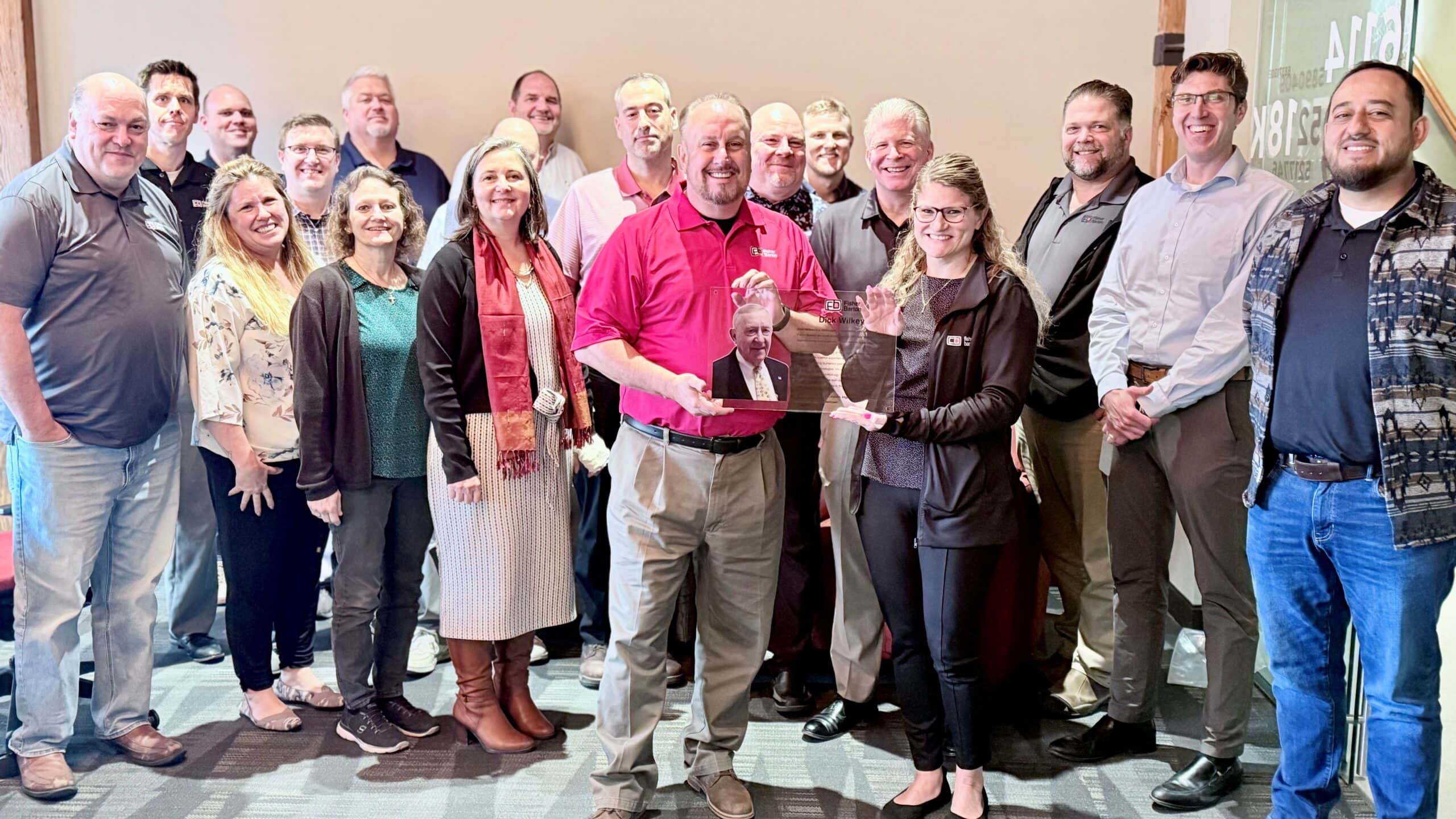 A portion of the Fisher Barton Team gathers to celebrate the new Dick Wilkey Conference Room