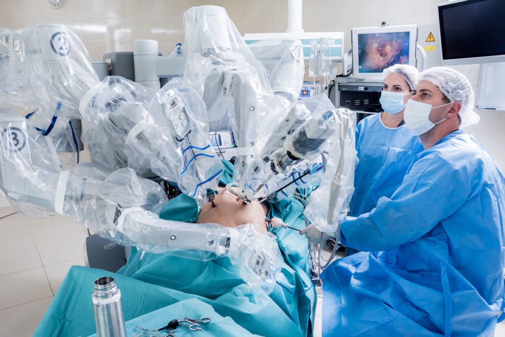 Operating Room with surgeons preforming robotic surgery